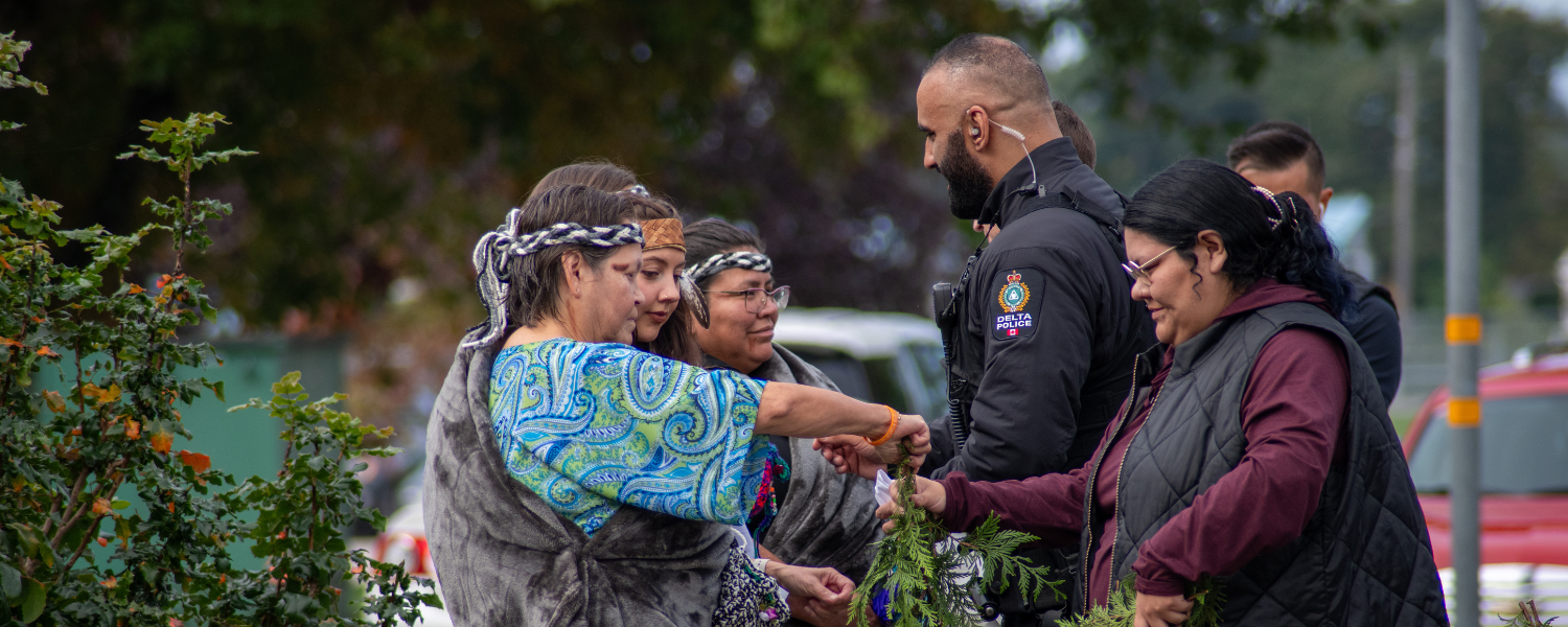 Constable with Tsawwassen First Nations members during ceremony