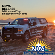 Delta Police Truck on beach during sunrise with 2024 BC Top Employers Badge